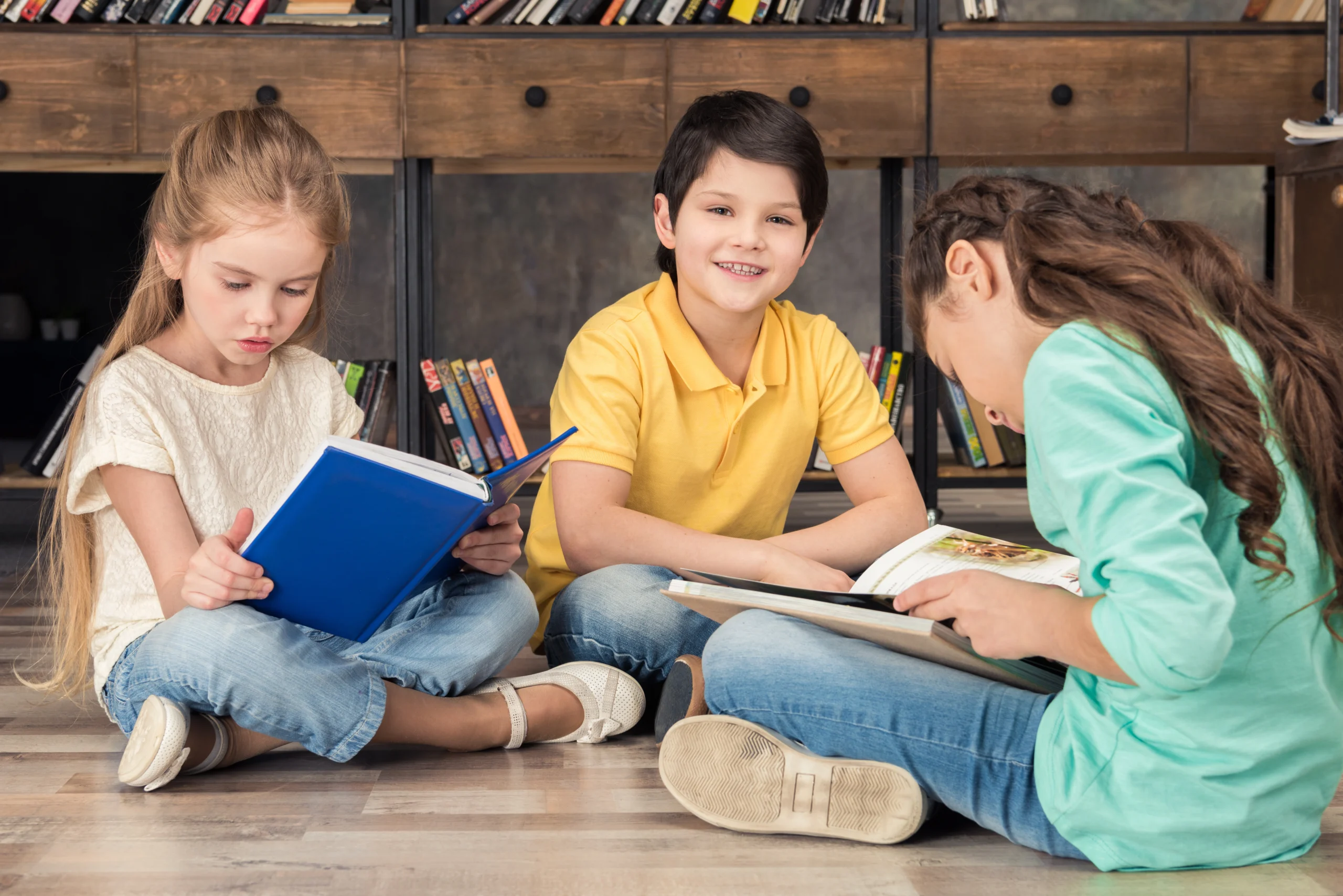 boy-and-girls-reading-books-in-library-2024-11-18-22-50-51-utc