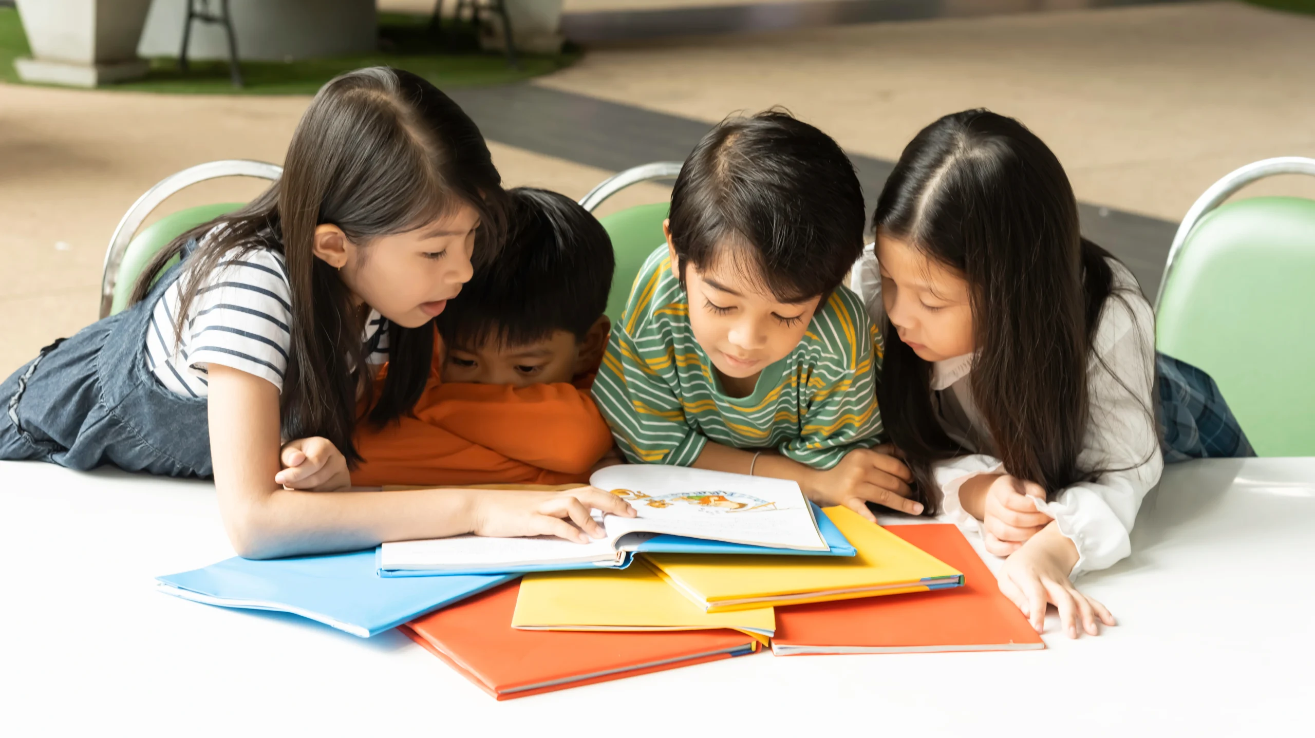four-children-siit-and-reading-book-at-school-fun-2025-10-28-21-47-01-utc