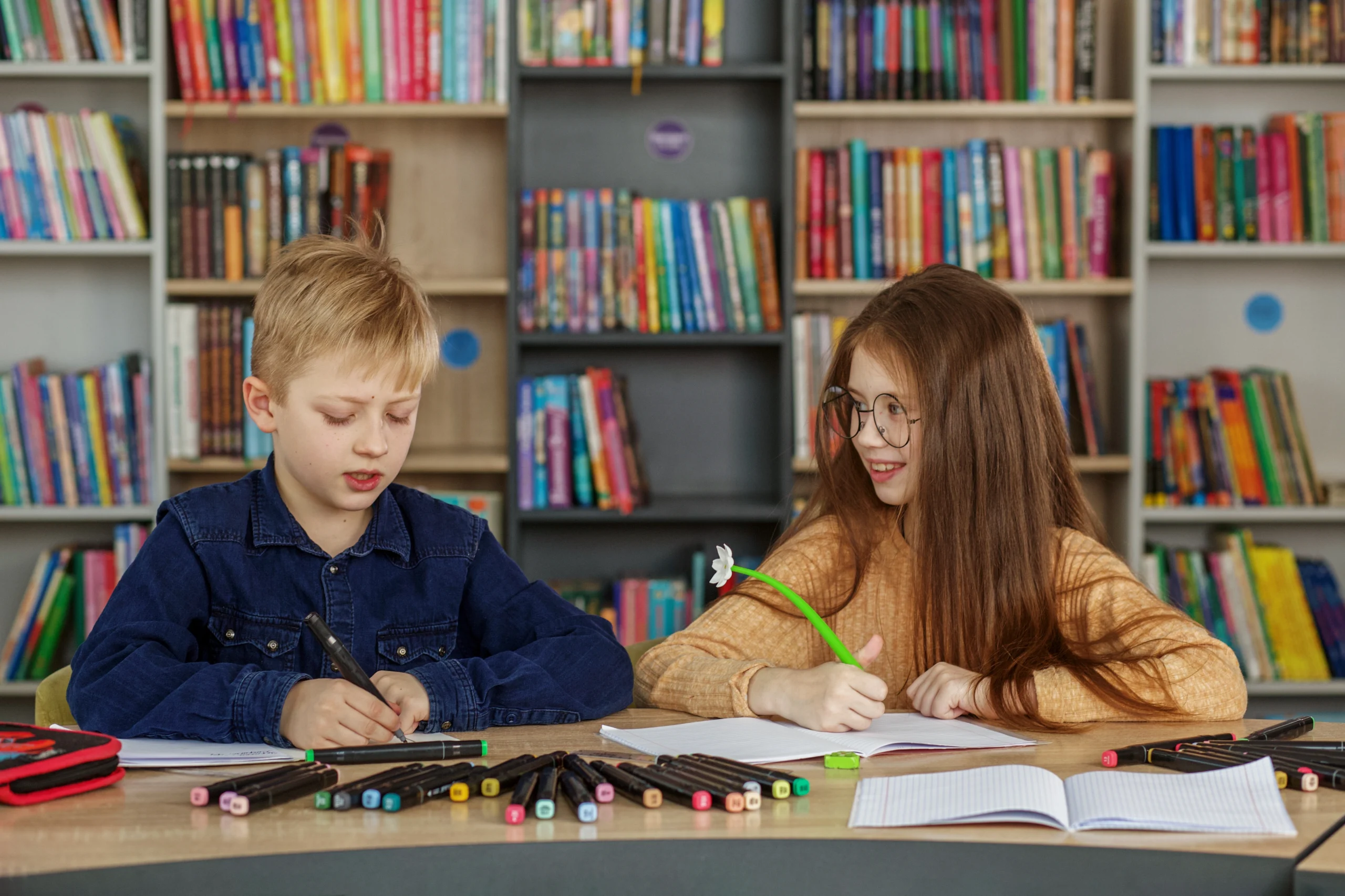 two-schoolchildren-write-and-draw-sitting-at-table-2025-04-01-19-38-38-utc